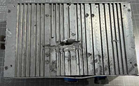 Power distribution unit (PDU) — Finned case with shrapnel damage and two round connectors