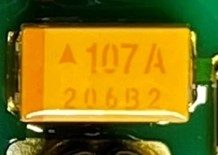 Tantalum capacitor, marked Δ107 A 206B2