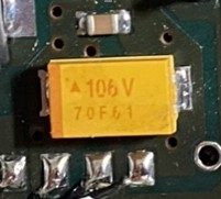 Tantalum capacitor, marked Δ106V 70F61