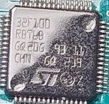 A 32-bit microcontroller, marked STM32F100RBT6B GQ20G 93 11 CHN GQ 239